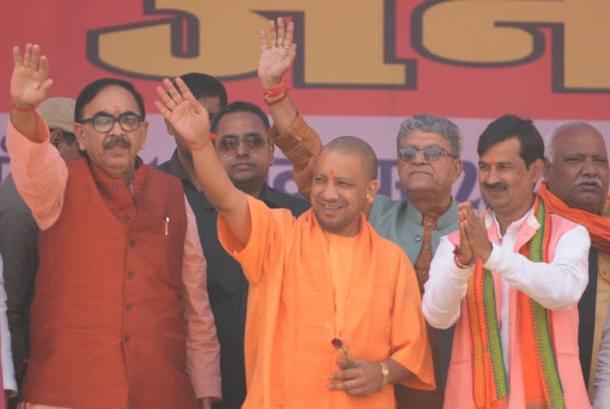 Chief Minister Uttar Pradesh Yogi Adityanath waves his hand to the crowd along with BJP state president Mahendra Nath Pandey and BJP mayor candidate for Ayodhya and Faizabad. (Deepak Gupta/Hindustan Times via Getty Images)